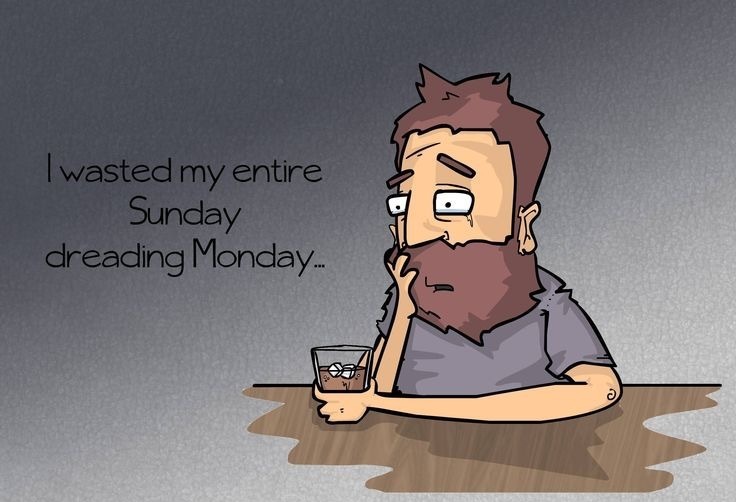 A woman sitting alone on her couch in the evening, looking anxious and withdrawn, symbolizing the emotional experience of the Sunday scaries.